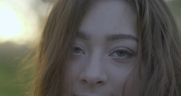 Closeup of Brown Hared Girl with Grey Eyes Spinning Around