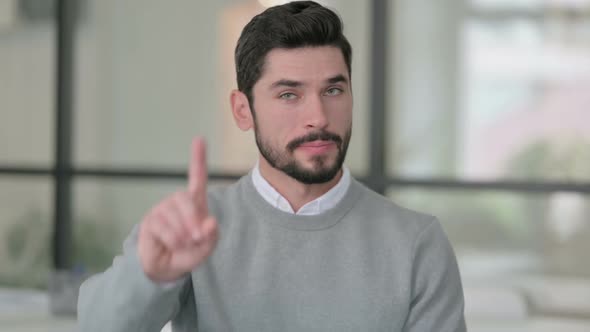 Portrait of Young Man Showing No Sign By Finger Sign