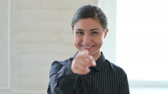 Young Indian Woman Pointing at the Camera 