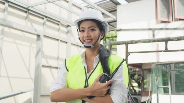 Portrait of Asian woman worker people wearing protective helmet working in construction site.