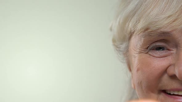Elderly Smiling Woman Showing Grapefruit Slice, Anti-Aging Food, Diet Calories