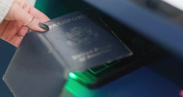 Hand Scanning US Passport Citizen at Self Checkin Station in Airport Terminal