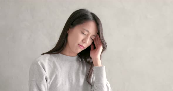 Asian woman feeling headache
