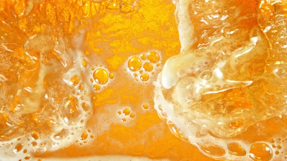 Super Slow Motion Shot of Rippling Fresh Beer Wave From Top Shot at 1000Fps