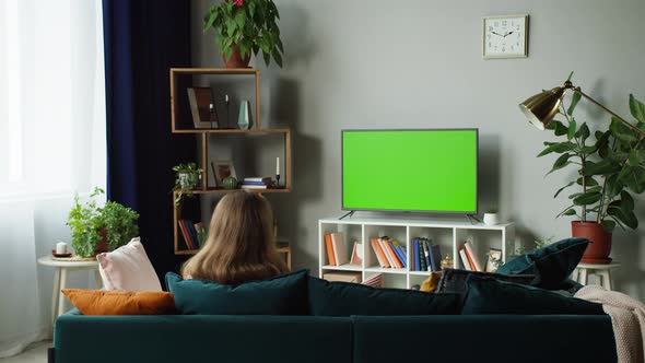 Woman Watching Television with Green Screen