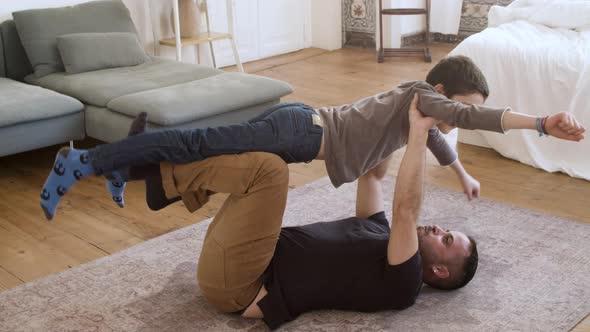 Happy Single Father Playing with His Son at Home / Videohive