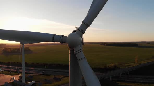 Drone Shooting Closeup of the Rotating Blades of a Windmill Against the Backdrop of Green Meadows