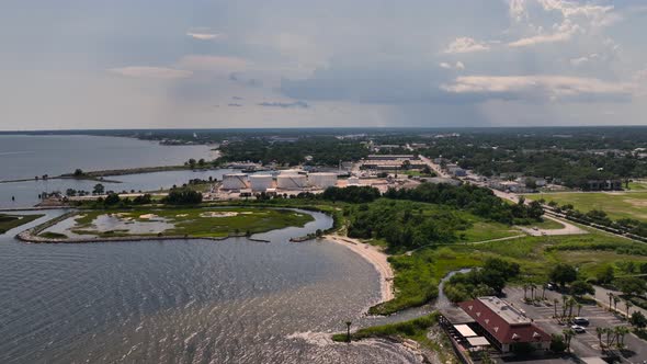 Aerial approaching tank farm along Santa Rosa Sound in Pensacola, Florida