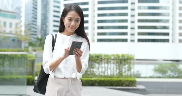 Young Woman use of mobile phone in city