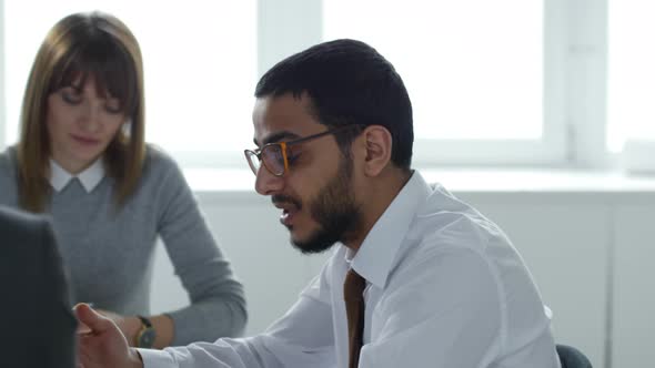 Middle Eastern CEO Talking to Employees in Office