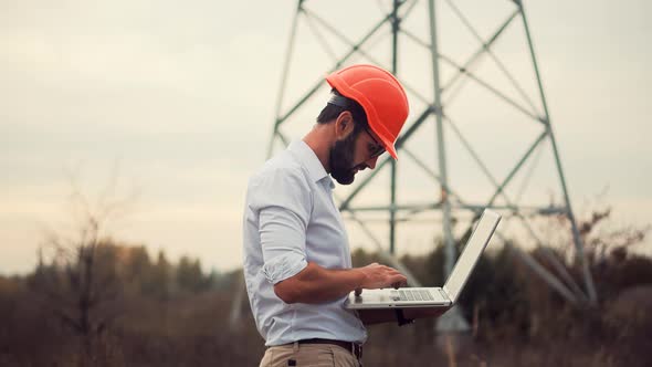 Civil Engineer Architect On Electricity Transmission Power Lines. Contractor On Construction Site.