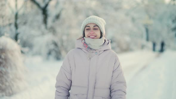 Slow Motion Cheerful Beautiful Woman Walking in Winter Park After Snowfall