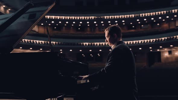 Handsome Pianist Playing on a Grand Piano