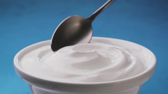 Bowl of Sour Cream on Blue Background Greek Yogurt