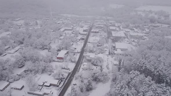 Aerial Flying Over Small Town In Winter Blizzard