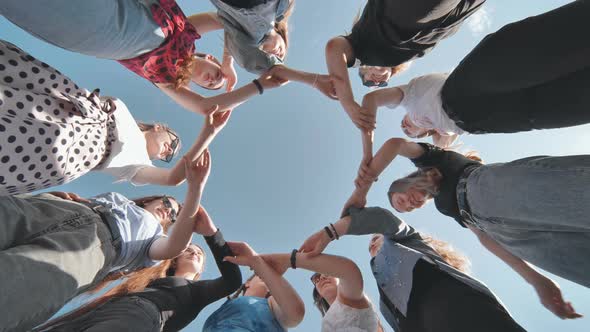 A Group of Girls Makes a Circle Shape Holding Each Other's Hands