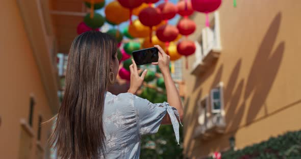 Woman take photo on mobile with chinese lantern at outdoor