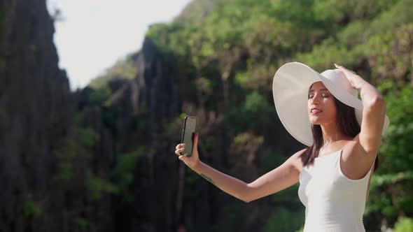 Woman Smiling In Sun Hat To Pose For Selfie On Smartphone