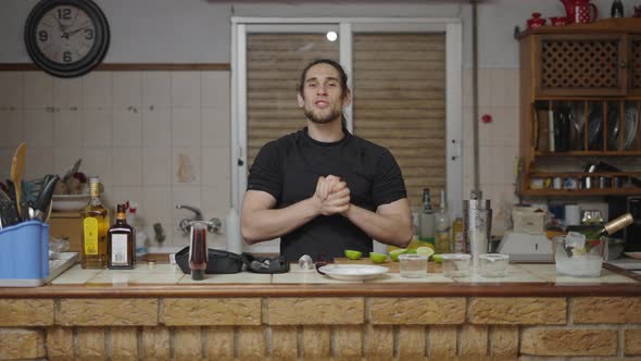 Barman Introducing New Cocktail Tutorial for His Channel in a Traditional Spanish Kitchen