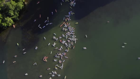 Aerial view above a group of SUP boarders on the Colorado river in Austin, USA - rotating, top down,