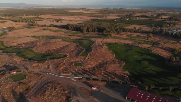 Stunning aerial flight over a Southern California golf course.  Perfectly manicured greens and fairw