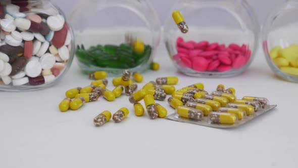 Macro shot of dropping yellow and brown granule capsule in bunch quantity