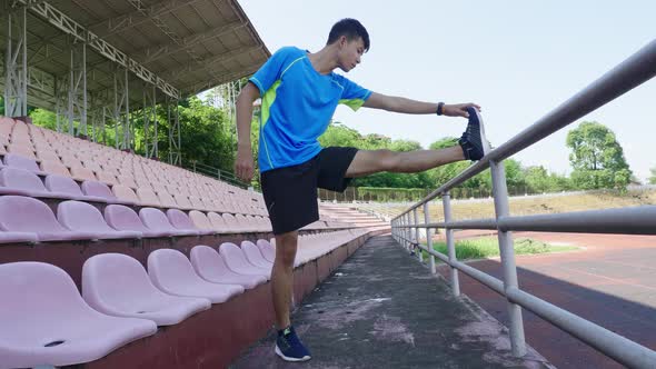 Man Stretching Leg At Stadium