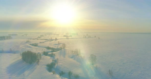 Aerial View of Cold Winter Landscape Arctic Field Trees Covered with Frost Snow Ice River and Sun