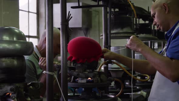 Mixed race man working at a hat factory