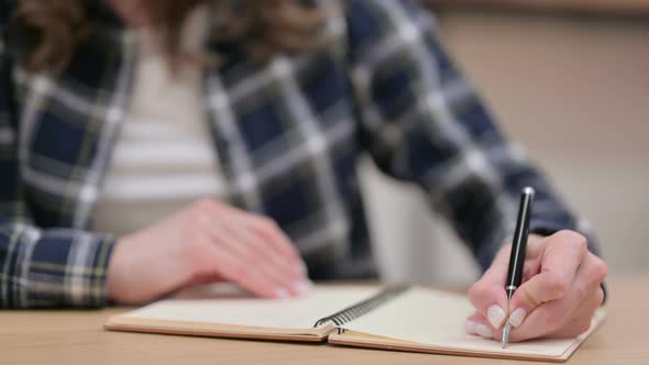 Female Hands Writing on Notebook Close Up