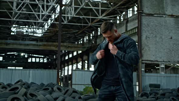 Man standing against ruin building. Young man posing against old building background