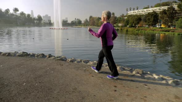 Senior Woman Working Out In The Park