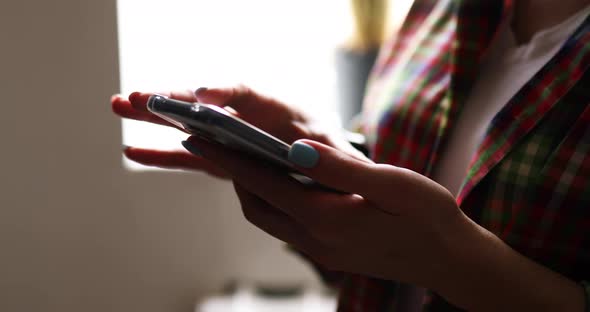 Unregonaizeble woman scrolling trough her smartphone screen