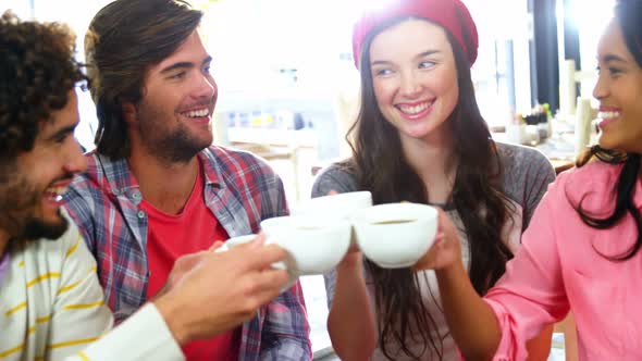 Group of friends toasting cup of coffee