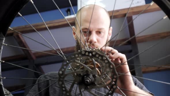 Man fixing a bike wheel