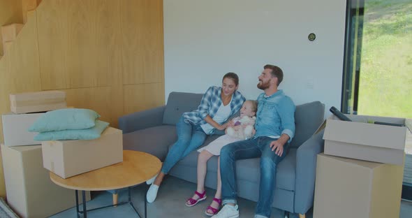 Family Take A Break On Sofa On Moving Day