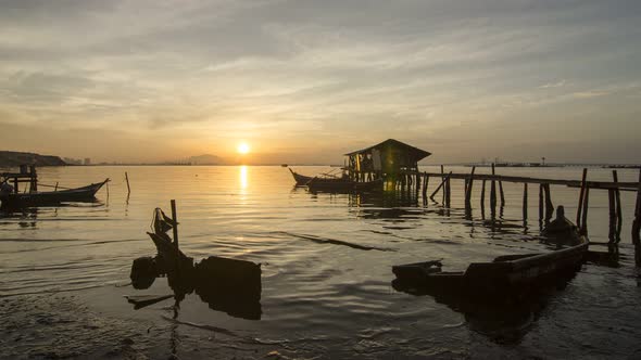 Timelapse Sunrise Dove Jetty with broken boat and wooden fisherman house