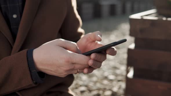 Close Up Shot of a Man's Hands, Who Dials a Phone Number To Call a Friend