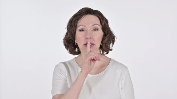Old Woman with Finger on Lips on White Background 