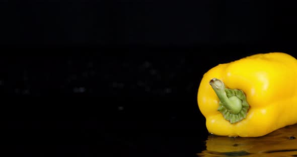 One Yellow Sweet Pepper Rotating on the Table. 