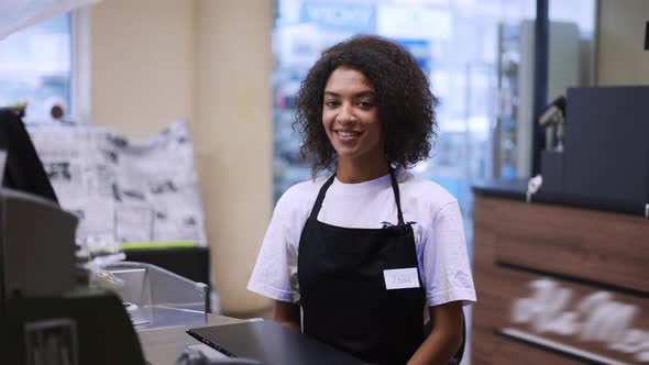 Portrait of an African American Worker at Grocery Store Checkout Friendly Smiling