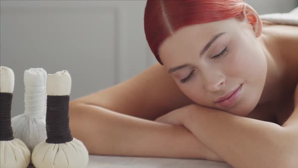 Beautiful woman getting beauty and relaxation treatment procedures in spa salon.