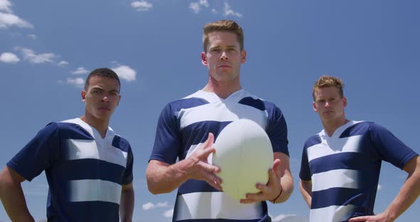 Rugby players standing with ball