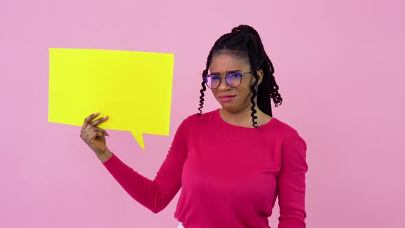 Cute Young African American Girl Stands with Posters for Expression on a Solid Pink Background