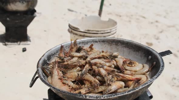 Cooking Shrimp in a Deep Pot on a Sandy Beach in Africa Exotic Zanzibar Island