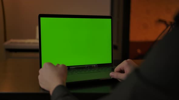 Faceless Male Making Online Call Via Laptop Webcam with Chromakeyed Display