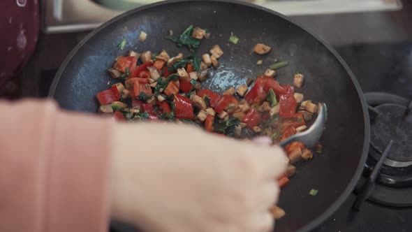 Close Up Shot of the Chef's Hand, Who Cooks a Delicious Dinner in a Frying Pan