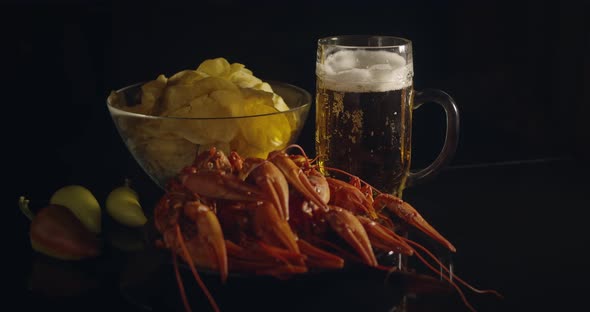 Close Up View of Lobsters with Foamy Bear and Chips on Background in Slow Motion