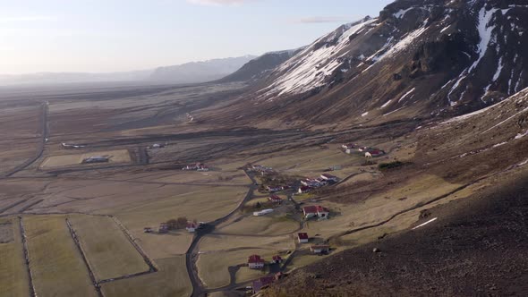 Small Secluded Farm Next to a Snowy Mountain in the Winter