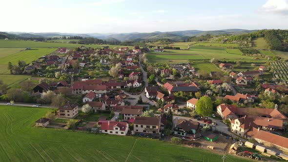 Czech scenic village aerial drone view. Beautiful village and fields with sunset